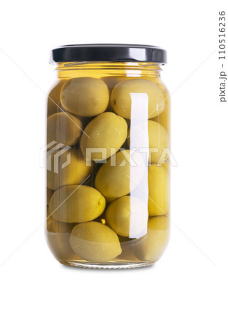 Green olives with pit, pickled whole, large Greek table olives, in a glass jar with screw cap. Whole fruits, picked when they are still unripe and of bitter taste, preserved in a brine. Front view. Green olives with pit, pickled whole, large Greek table olives, in a glass jar with screw cap. Whole fruits, picked when they are still unripe and of bitter taste, preserved in a brine. Front view. 110516236