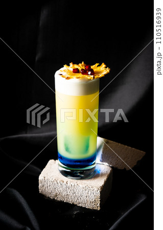 cocktail - blue curacao, infused rum with passion fruit, apple syrup, pineapple juice and lime juice 110516939