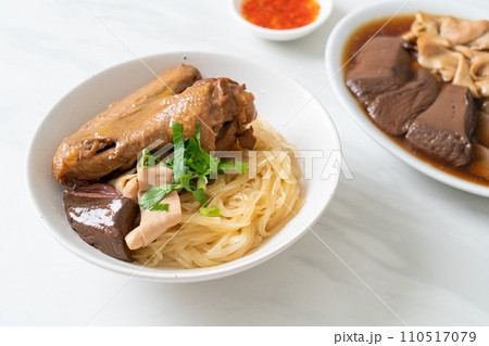 dried noodles with braised duck in white bowl 110517079