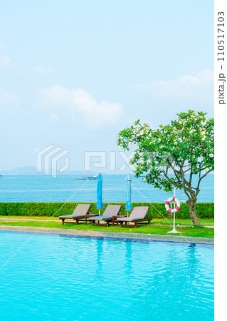 chair pool and umbrella around swimming pool 110517103