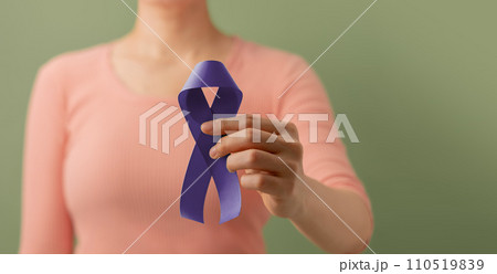 Cancer Awareness Campaign Concept. Global Healthcare. World Cancer Day. Close up of a Young Female Brings a Violet Ribbon into the Front. 110519839