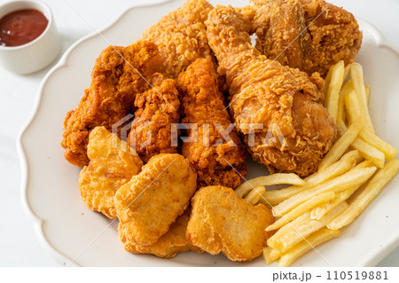 fried chicken with french fries and nuggets on plate 110519881