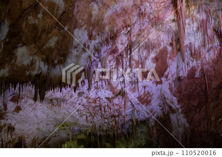 Karst cave, amazing view of stalactites and stalagnites in colorful bright light, beautiful natural landmark in touristic place. 110520016
