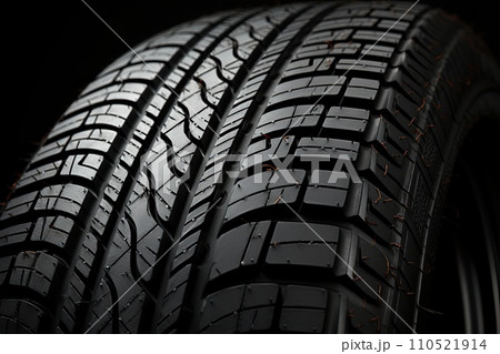 New black tires pile on a dark black background close-up. Tire fitting background with stack of car tires. Copy space. Generative AI 110521914