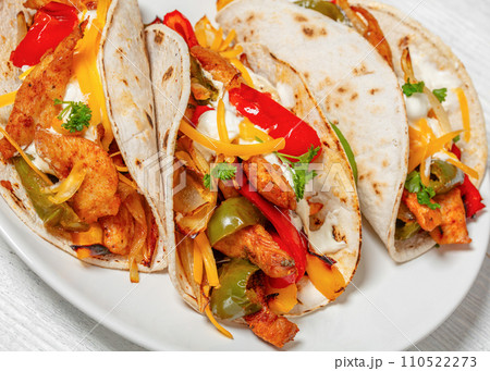 baked tex-mex chicken fajitas on a plate, top view baked tex-mex chicken fajitas on a plate, top view 110522273