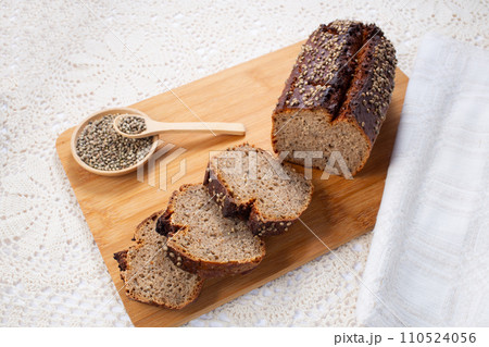 Fresh baked loaf of spelt sourdough bread with hemp seeds is on linen towel. Healthy pastry Fresh baked loaf of spelt sourdough bread with hemp seeds is on linen towel. Healthy pastry 110524056