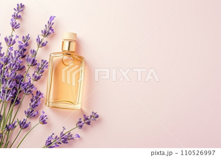 Elegant flat lay of body oils and perfume bottles with lavender sprigs on a pastel background, minimalist style Elegant flat lay of body oils and perfume bottles with lavender sprigs on a pastel background, minimalist style 110526997
