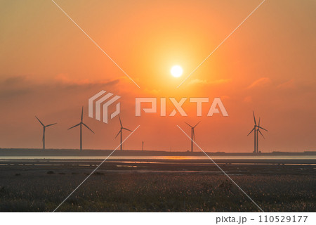 Offshore wind farms are great for enjoying the scenery and watching the sunset. Offshore wind farms are great for enjoying the scenery and watching the sunset. 110529177