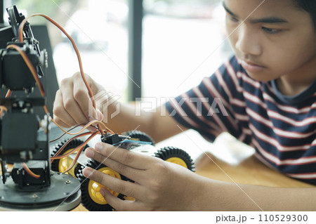 Asian teenager doing robot project in science classroom. technology of robotics programing and STEM education concept. 110529300