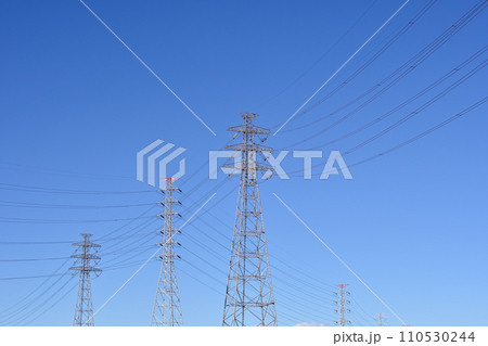 青空にそびえ立つ送電線と鉄塔 110530244