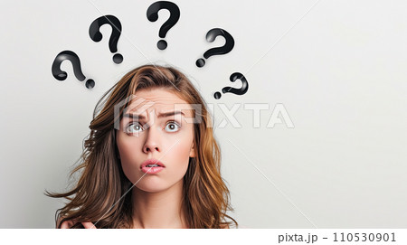 Portrait of a woman with perplexed facial expression; some black question marks above her head 110530901