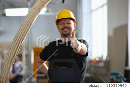 Smiling worker in yellow helmet show confirm sign Smiling worker in yellow helmet show confirm sign 110530940