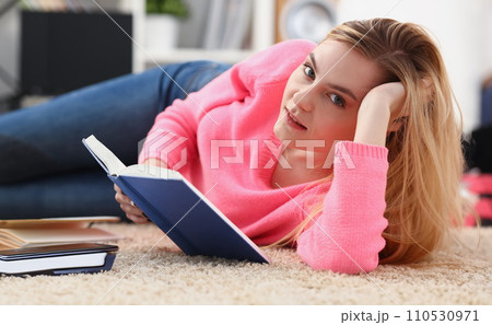young beautiful blond woman lie on the floor read book young beautiful blond woman lie on the floor read book 110530971