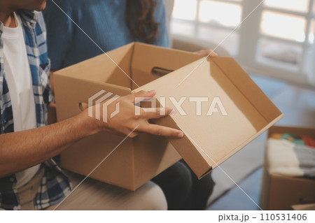 Two Asian blogger showing clothes in front of the camera to recording vlog video live streaming at her shop. Online Shopping Cart notion. on sofa at home Two Asian blogger showing clothes in front of the camera to recording vlog video live streaming at her shop. Online Shopping Cart notion. on sofa at home 110531406