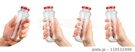 Hands holding empty glass transparent bottle closed with cap isolated on white background Hands holding empty glass transparent bottle closed with cap isolated on white background 110532999