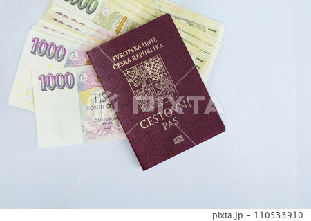 Czech Republic passport are stacked various denominations CZK koruna banknotes cash stacked on white background Czech Republic passport are stacked various denominations CZK koruna banknotes cash stacked on white background 110533910