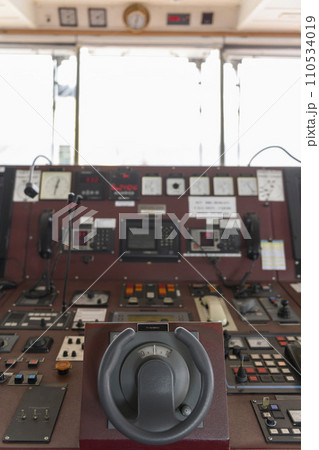 Ship's control device. Engine control from navigational bridge. Focused on helm, blured background. 110534019