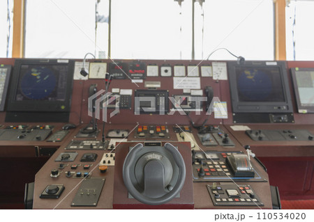 Ship's control device. Engine control from navigational bridge. Focused on helm, blured background. Ship's control device. Engine control from navigational bridge. Focused on helm, blured background. 110534020