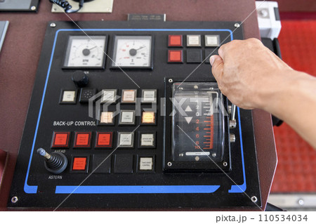 Navigational control panel with hand. Ship engine control. Navigational bridge. Navigational control panel with hand. Ship engine control. Navigational bridge. 110534034