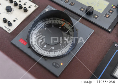 Gyro compass repeater on the navigational control pane of navigational bridge. Navigational equipment. Gyro compass repeater on the navigational control pane of navigational bridge. Navigational equipment. 110534036