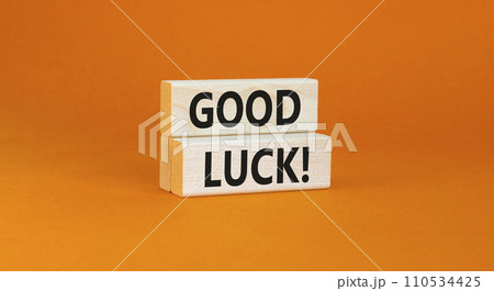 Good luck symbol. Concept words Good luck on beautiful wooden block. Beautiful orange table orange background. Business, motivational good luck concept. Copy space. 110534425
