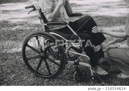 young asian physical therapist working with senior woman on walking with a walker 110534624