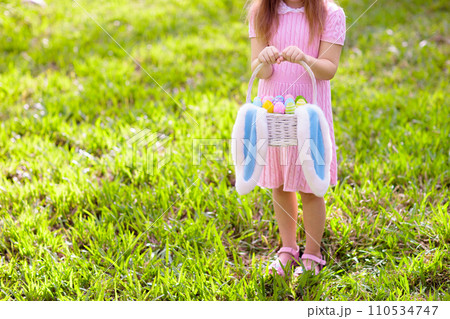 Kids with eggs basket on Easter egg hunt. Kids with eggs basket on Easter egg hunt. 110534747