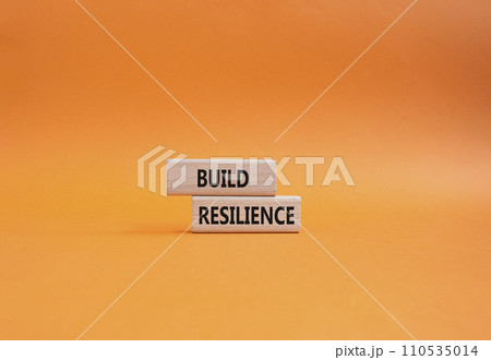 Build resilience symbol. Wooden blocks with words Build resilience. Beautiful orange background. Business and Build resilience concept. Copy space. 110535014