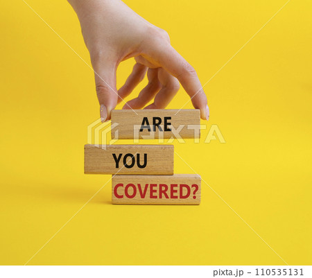 Are you covered symbol. Concept words Are you covered on wooden blocks. Businessman hand. Beautiful yellow background. Business and Are you covered concept. Copy space. Are you covered symbol. Concept words Are you covered on wooden blocks. Businessman hand. Beautiful yellow background. Business and Are you covered concept. Copy space. 110535131