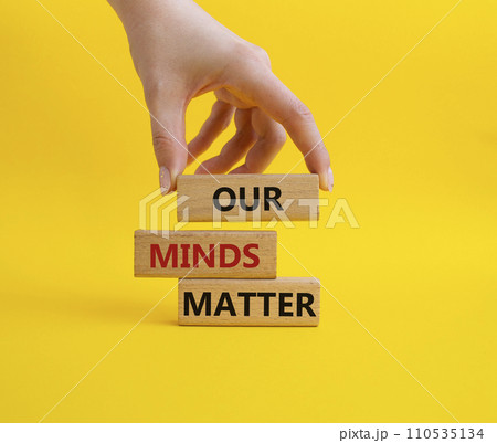 Our Minds Matter symbol. Concept words Our Minds Matter on wooden blocks. Doctor hand. Beautiful yellow background. Psychological social and Our Minds Matter concept. Copy space. 110535134