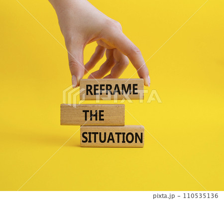 Reframe the situation symbol. Concept words Reframe the situation on wooden blocks. Beautiful yellow background. Businessman hand. Business concept. Copy space. 110535136