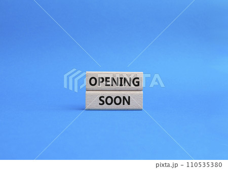Opening soon symbol. Concept word Opening soon on wooden blocks. Beautiful blue background. Business and Opening soon concept. Copy space 110535380