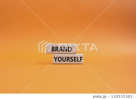 Brand yourself symbol. Concept word Brand yourself on wooden blocks. Beautiful orange background. Business and Brand yourself concept. Copy space 110535381