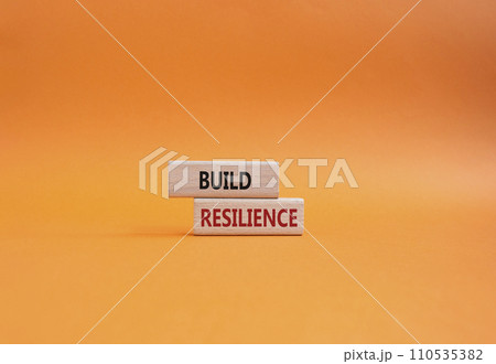 Build resilience symbol. Wooden blocks with words Build resilience. Beautiful orange background. Business and Build resilience concept. Copy space. 110535382