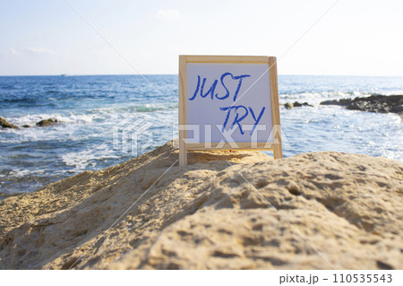 Just try symbol. Concept words Just try on white chalk background. Beautiful sea background. Business and Just Try concept. Copy space. 110535543