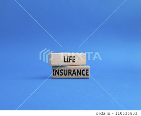 Life insurance symbol. Concept word Life insurance on wooden blocks. Beautiful blue background. Business and Life insurance concept. Copy space 110535833