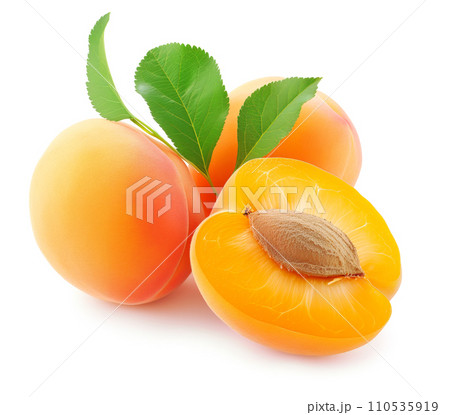 Ripe apricot fruits , one cut in half to reveal a stone, isolated on white 110535919