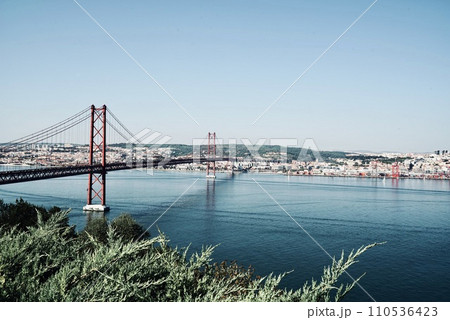 View of the Tagus River in Lisbon with the bridge of the Ponte 25 de Abril, Lisbon Portugal 110536423