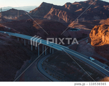 Hoover Dam on the Colorado River straddling Nevada and Arizona at dawn from above. Aerial view of Hoover Dam and the Colorado River Bridge 110536565