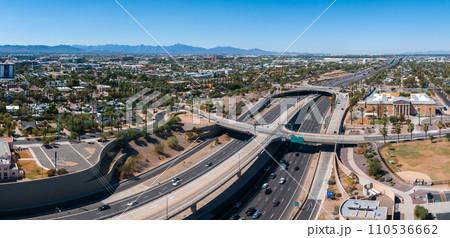 Aerial view of the highway and crossroads intersections in Phoenix, USA. Top up aerial drone view of elevated road and traffic junctions in USA metropolis during sunny day. 110536662