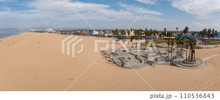 Skate board park in Venice beach with people skating by the Pacific ocean. Best and most popular skate park in the world. 110536843