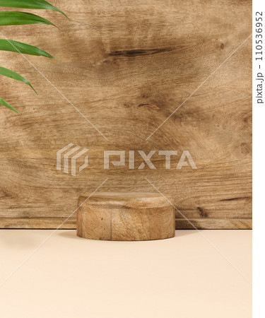 Round wooden platform, shadow from a palm leaf on a brown background. Round wooden platform, shadow from a palm leaf on a brown background. 110536952