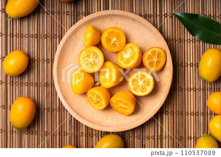 Kumquat fruits on the table. Many kumquat fruits. 110537089