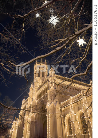 Magical illumination of the building of the New Peterhof railway station near St. Petersburg on a winter evening, Christmas decorations on trees Magical illumination of the building of the New Peterhof railway station near St. Petersburg on a winter evening, Christmas decorations on trees 110537631
