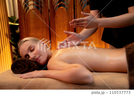 Caucasian woman customer enjoying relaxing anti-stress massage. Quiescent 110537773