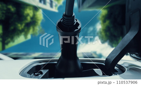 Future EV charger plugged into electric car for electric recharging. Peruse Future EV charger plugged into electric car for electric recharging. Peruse 110537906