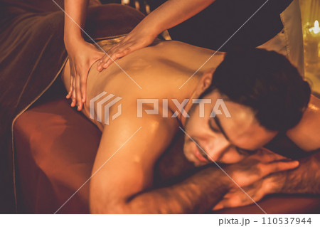Caucasian man customer enjoying relaxing anti-stress massage. Quiescent Caucasian man customer enjoying relaxing anti-stress massage. Quiescent 110537944