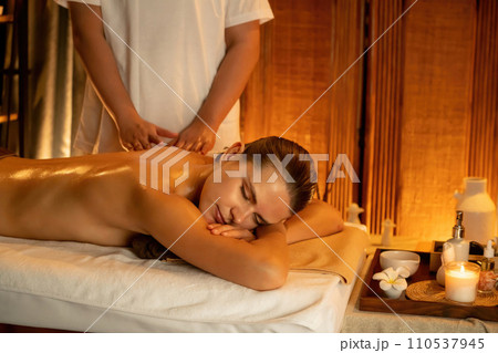 Caucasian woman customer enjoying relaxing anti-stress massage. Quiescent Caucasian woman customer enjoying relaxing anti-stress massage. Quiescent 110537945