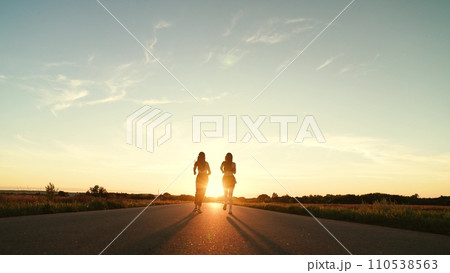 two friends running sunset, team group girls running sunset, silhouette athletic girls, teamwork motivation running with fitness woman, athlete cardio training, athlete runner training stadium 110538563