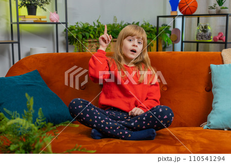 Thoughtful inspired child girl kid make Eureka gesture raises finger came up with creative plan 110541294